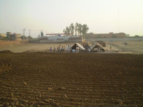 Phase 2 site crew on a break at the cleared plot