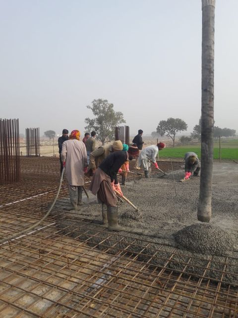 Phase 2 workers finishing a concrete slab pour